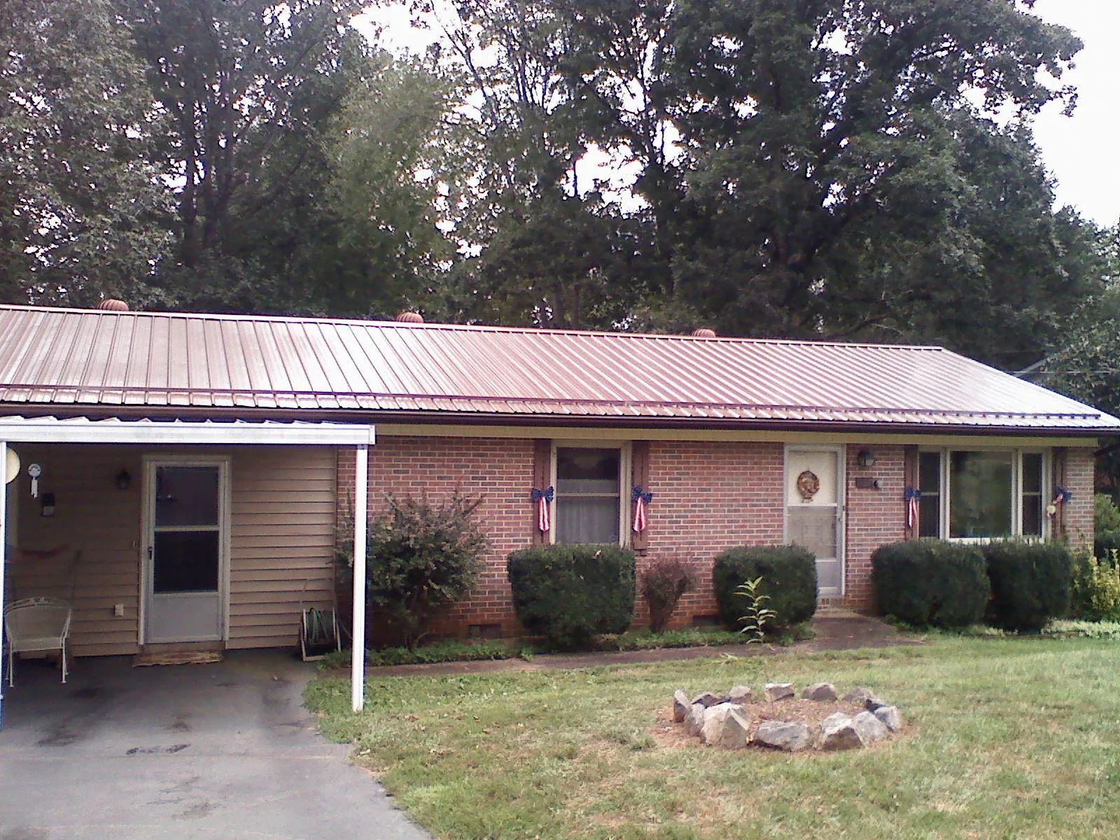 Bronze metal roof and carport on a brick ranch home — Roof Repair work by our crew in Macedon
