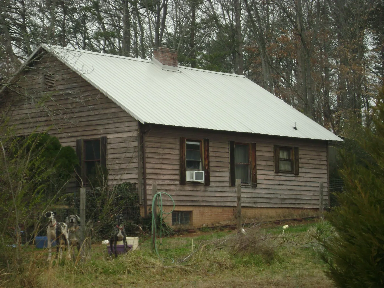 White metal roof on an old wood sided farmhouse, from a Metal Roof Installation job in Macedon